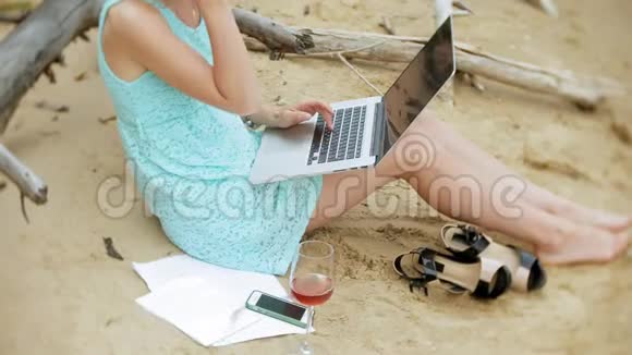 一个忙碌的年轻女子正在用一台手提电脑手里拿着商业文件拿起一个电话坐着打电话视频的预览图