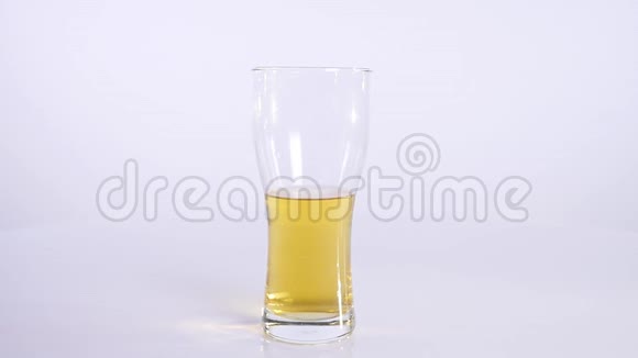 一瓶啤酒倒入白色背景的杯子里视频的预览图