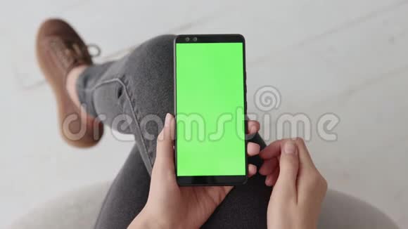 家中年轻女性移动智能手机的绿色屏幕显示色度键视频的预览图