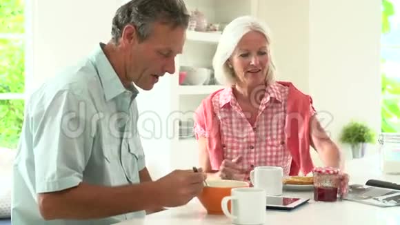 中老年夫妇在厨房一起吃早餐视频的预览图