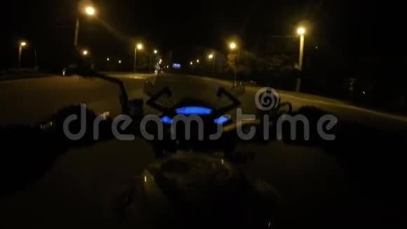 一名骑摩托车的人在傍晚的城镇道路上高速行驶摩托车驾驶的观点视频的预览图