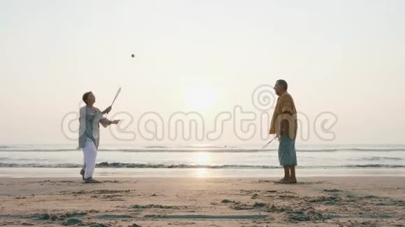 活跃的老夫妇在海滩上打太极球视频的预览图