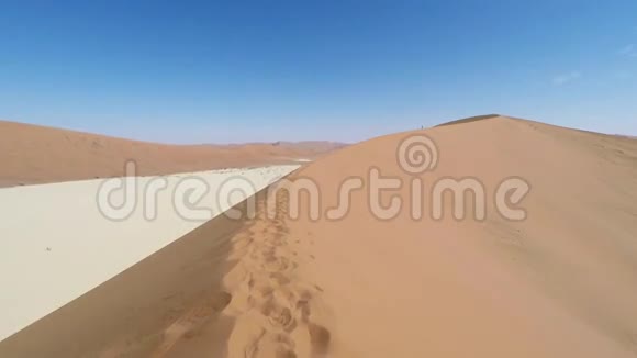 在雄伟的纳米布沙漠中行走的游客视频的预览图