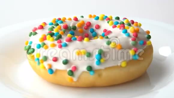 美味的甜圈白色糖霜旋转在白色的盘子上白色背景失踪了视频的预览图
