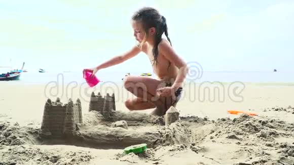 泰国沙滩上玩沙子的金发女孩视频的预览图