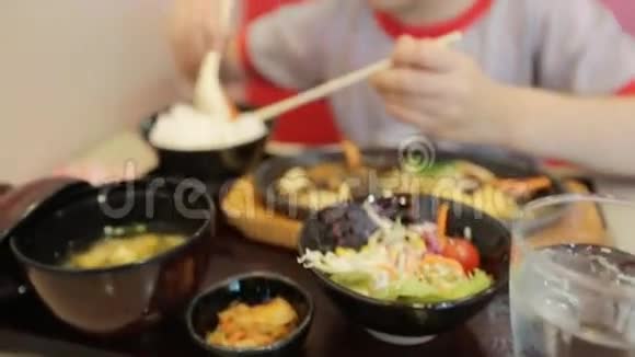 快乐的亚洲孩子在餐厅吃寿司面带笑容视频的预览图