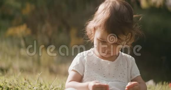 可爱的女婴在夏末探索公园视频的预览图