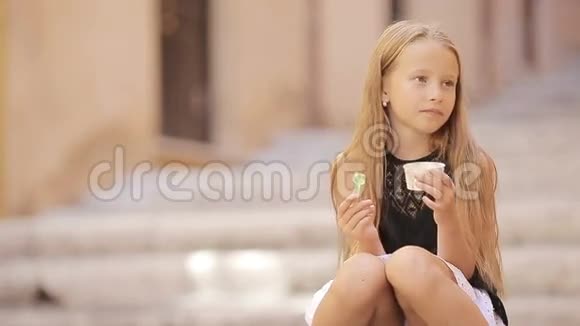 可爱的小女孩在户外夏天吃冰淇淋可爱的孩子在罗马享受真正的意大利冰淇淋视频的预览图