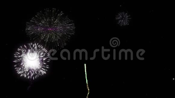 庆祝在黑色夜空上的烟火颗粒和火花与彩色慢动作烟花在背景上的问候视频的预览图