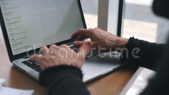 一个年轻的商人在一家有笔记本电脑的咖啡馆工作视频的预览图