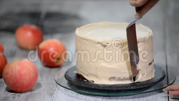 厨师用奶油装饰一个美味的蛋糕制作焦糖苹果蛋糕视频的预览图