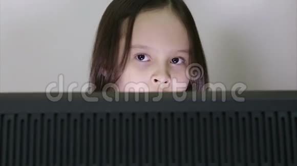 女孩看着电脑屏幕视频的预览图