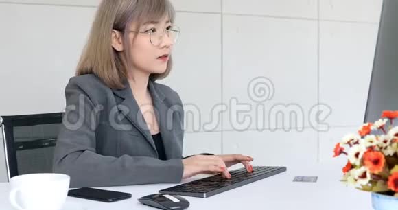 亚洲女商人在办公室里用电脑视频的预览图