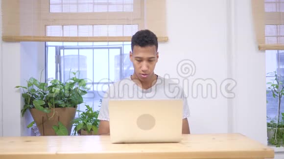 成功成功的非洲男人在笔记本电脑上工作视频的预览图