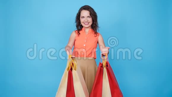 快乐的年轻女人拿着购物袋视频的预览图