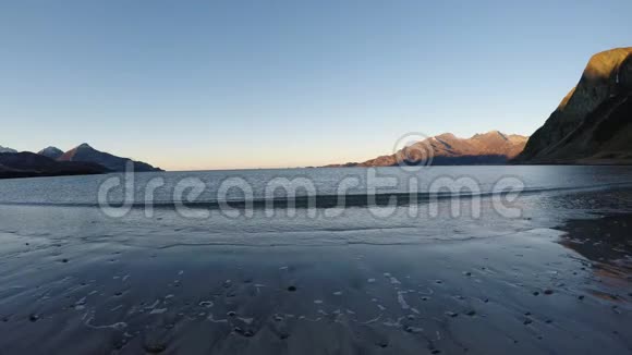 深秋美丽平静的蓝色海浪拍打着白色冰冻的沙滩视频的预览图