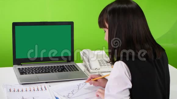 绿色屏幕笔记本电脑在一个办公桌上的女工工作室视频的预览图
