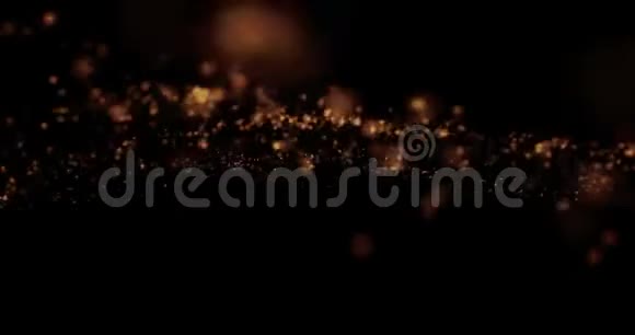 圣诞金光闪闪的粒子模糊在黑色背景上盘旋节日祝贺祝福晚会快乐视频的预览图