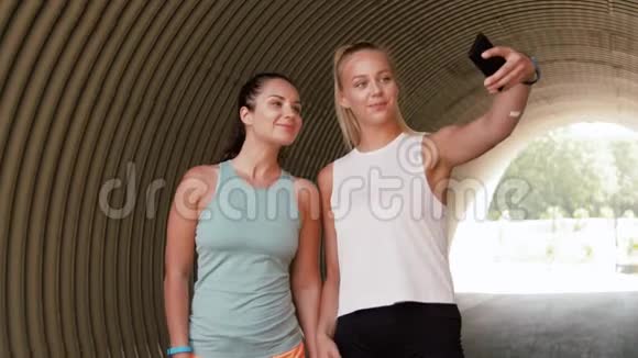 户外智能手机自拍的运动女性视频的预览图