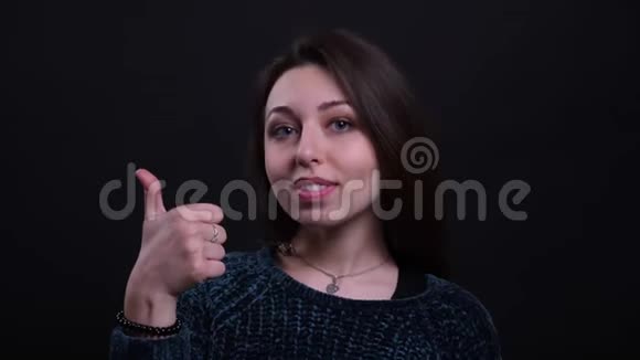 成年白种人深色头发的女性的特写照片她竖起大拇指微笑着看着镜头视频的预览图
