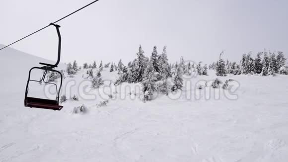 在雾蒙蒙的山上滑雪缆车上视频的预览图