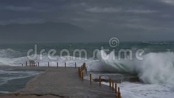 巨大的波浪在石头海岸上破浪前进视频的预览图