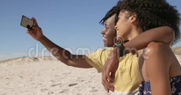 情侣在沙滩上用手机自拍4k视频的预览图