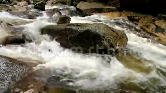 山河带寒晶水光滑的石头和泡沫的冷水水的噪音视频的预览图