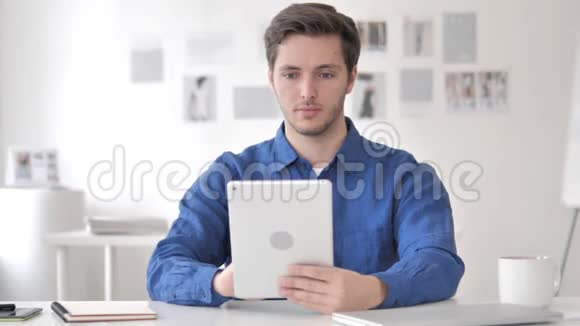 在办公室使用平板电脑的临时成年男子视频的预览图