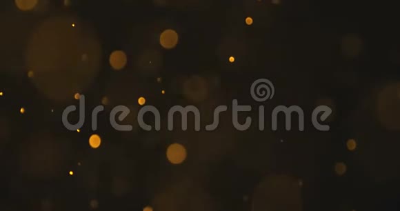 摘要金色辉光粒子对黑色背景的影响节日新年快乐视频的预览图