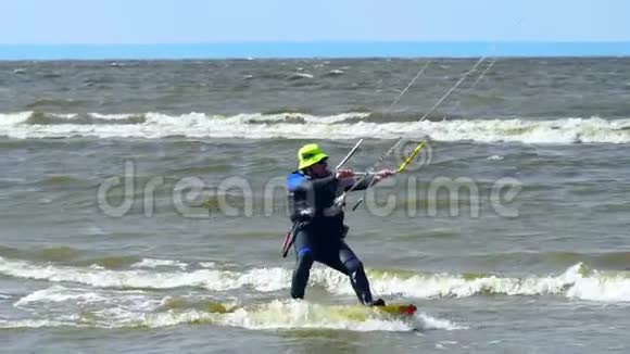 慢动作一位老人在做风筝他在池塘的波浪上美丽地骑着风筝强风视频的预览图