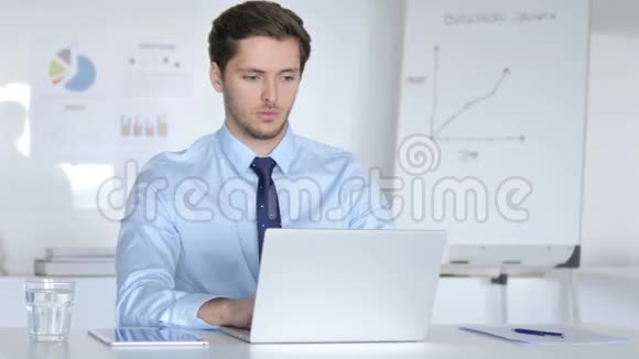 思考年轻的商人在笔记本电脑上工作视频的预览图
