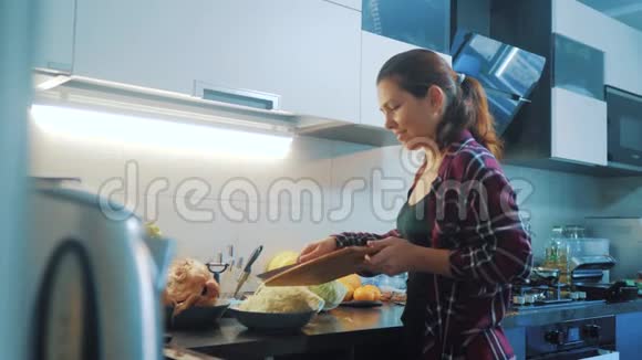 生活方式的女人在厨房准备饭菜的概念厨房里的女孩用刀切卷心菜做素食者视频的预览图