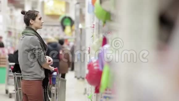 带着手推车穿过商店的女孩视频的预览图
