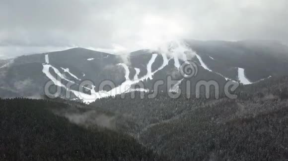 山上覆盖着白雪的滑雪场和圣诞树视频的预览图