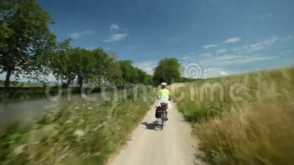 慢动作退休夫妇在河边骑自行车度假视频的预览图