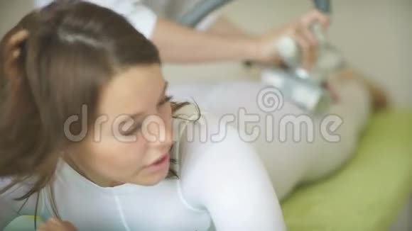 女人躺在客厅的床上接受脂肪按摩视频的预览图