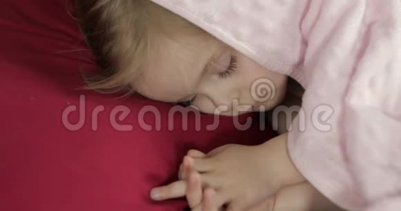 可爱的婴儿睡在家里的床上小女孩睡在晨光里视频的预览图