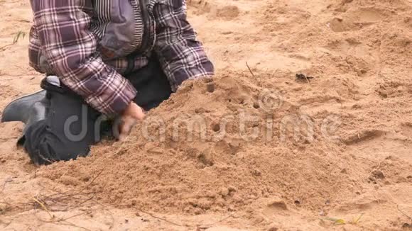 玩沙子的小孩的手视频的预览图