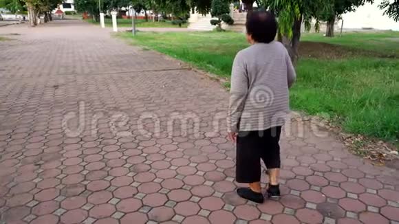 在公园里用手杖走路的老妇人视频的预览图