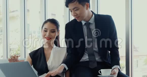 亚洲商人在办公室里使用笔记本电脑视频的预览图