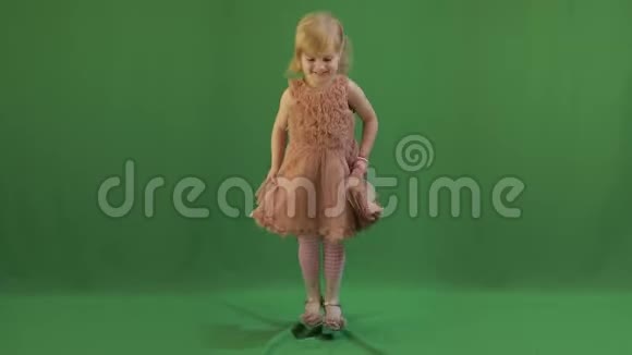 快乐的三岁女孩可爱的金发孩子棕色的眼睛绿屏视频视频的预览图