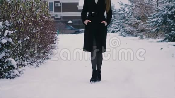 在圣诞树慢动作的背景下把穿黑色外套的女人贴身视频的预览图