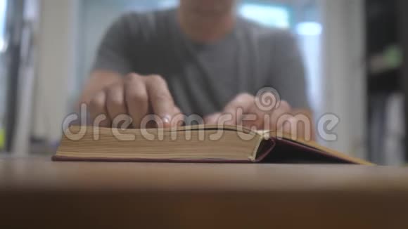 人在读一本书教育学习概念生活方式库男人打开书人把书页翻过来视频的预览图
