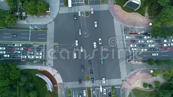 空中无人机在城市的十字路口汽车和公共汽车在大道上行驶日落时分视频的预览图