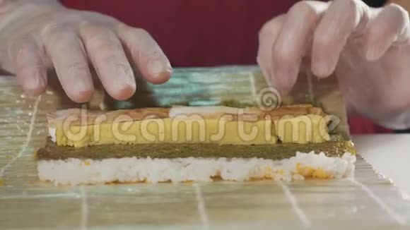 专业寿司厨师在商业厨房准备卷特写视频的预览图