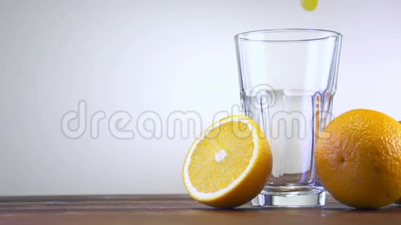 彩色背景下倒入杯中的橙汁视频的预览图