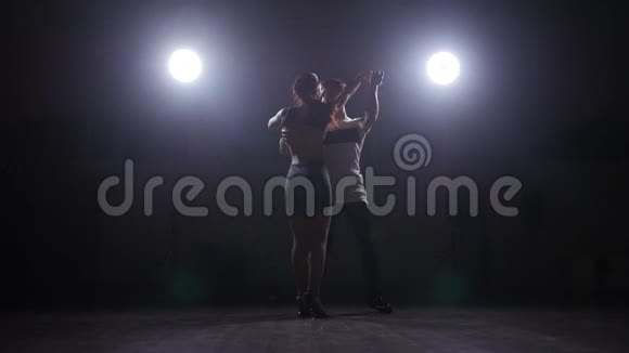 一对情侣在黑暗的房间里背光跳舞视频的预览图