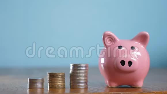 钱堆步增长钱和储蓄罐概念储蓄与储蓄罐和堆叠硬币小猪银行之间视频的预览图