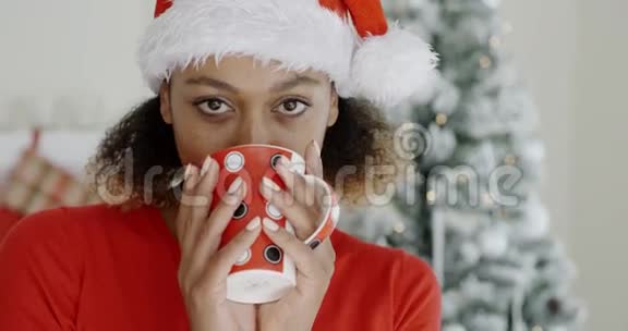 在圣诞节喝热咖啡的年轻女子视频的预览图